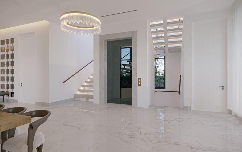 Entrance hall with lift and illuminated staircase