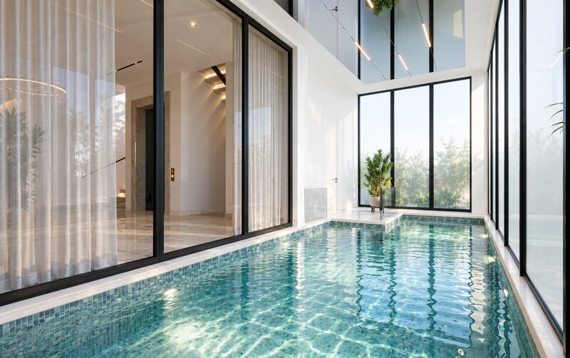 Indoor pool enclosed by double-height glazing